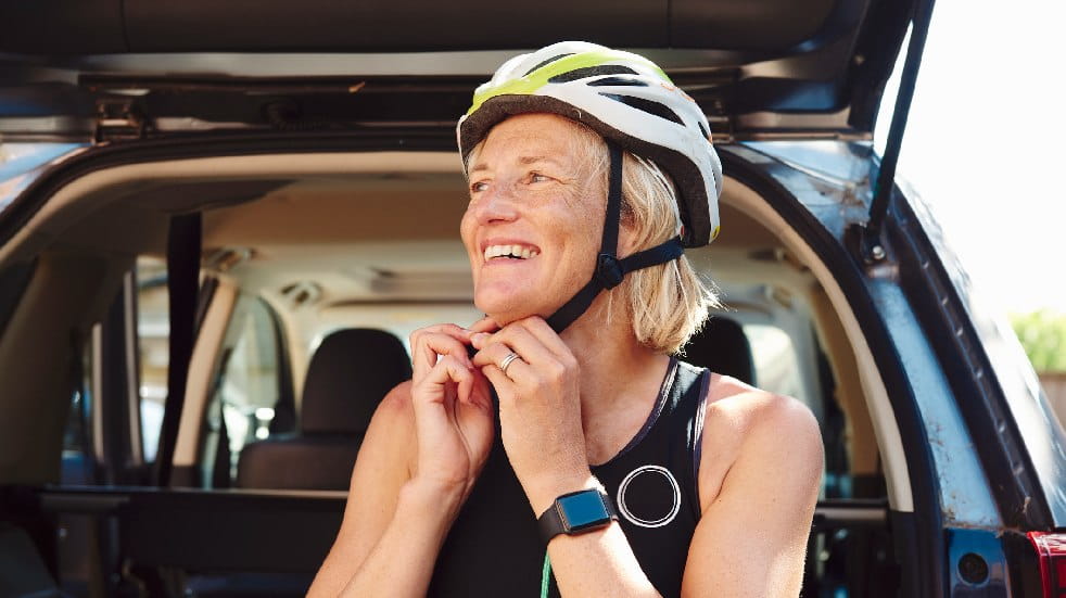 woman putting on bike helmet